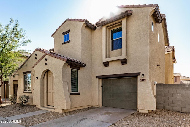 mediterranean / spanish home featuring a garage