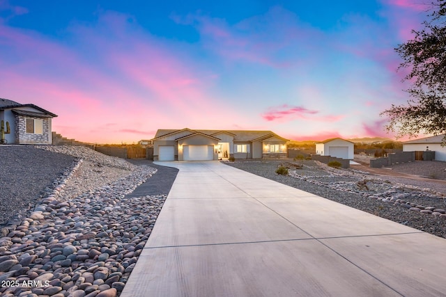 view of front of home with a garage, driveway, and fence