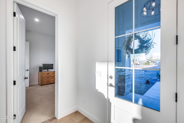 entryway with light carpet and baseboards