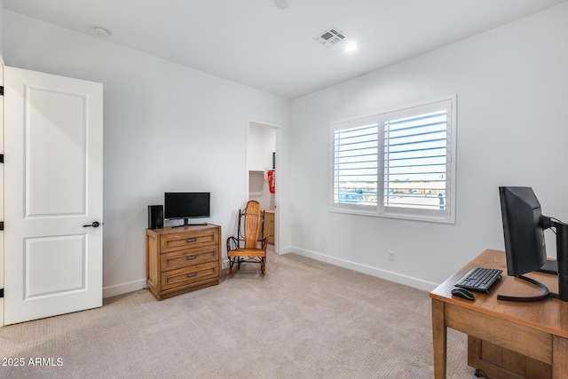 office space with light colored carpet, visible vents, and baseboards