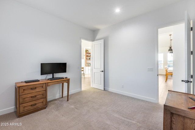 office space featuring recessed lighting, baseboards, and light colored carpet