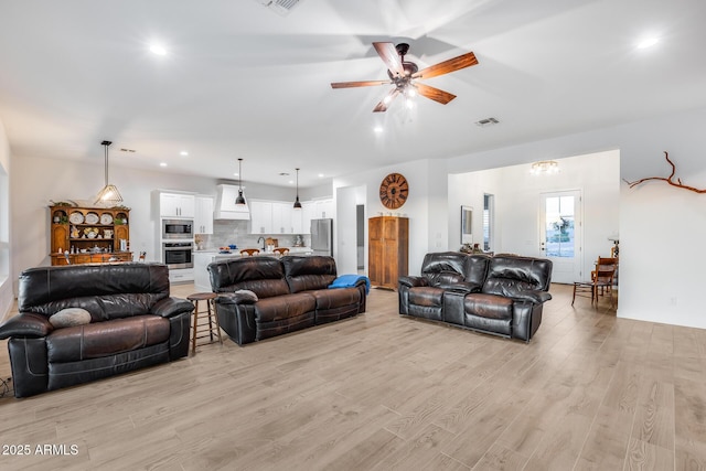 living area with light wood finished floors, ceiling fan, visible vents, and recessed lighting