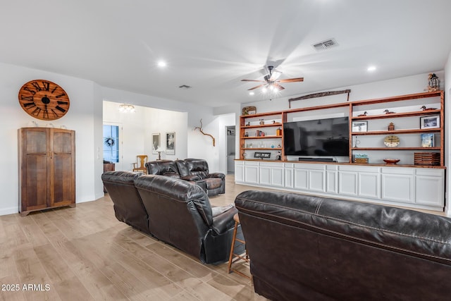 living room featuring light wood-type flooring, visible vents, ceiling fan, and recessed lighting