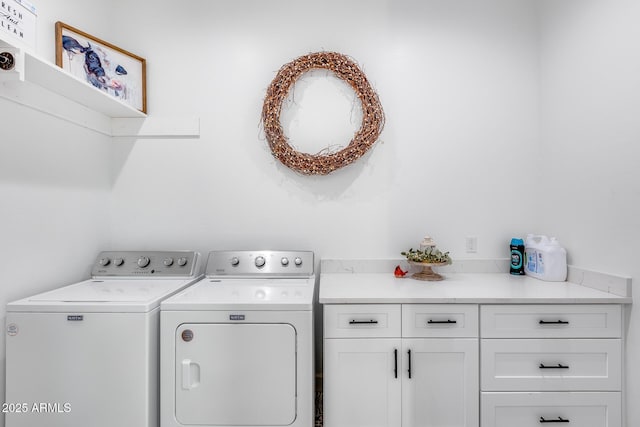 laundry room with washer and dryer and cabinet space