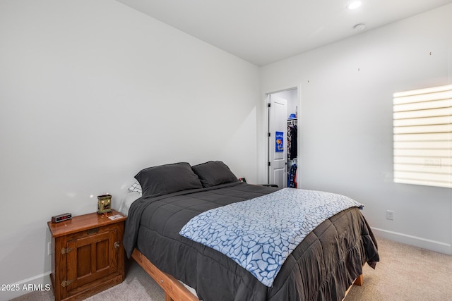 bedroom featuring light carpet and baseboards