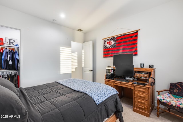 bedroom featuring light carpet, visible vents, and a closet