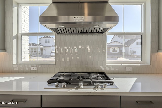 10972 N Hershey St, Surprise, AZ 85388 - kitchen featuring plenty of natural light, stainless steel gas stovetop, backsplash, and exhaust hood