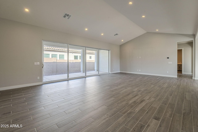 10972 N Hershey St, Surprise, AZ 85388 - empty room featuring vaulted ceiling, dark wood-type flooring, visible vents, and baseboards