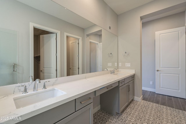 10972 N Hershey St, Surprise, AZ 85388 - full bath with double vanity, baseboards, a sink, and wood finished floors