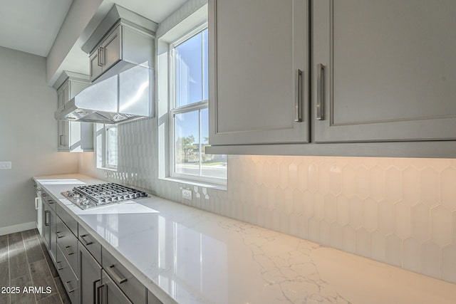 10972 N Hershey St, Surprise, AZ 85388 - kitchen featuring tasteful backsplash, baseboards, light stone countertops, gray cabinetry, and stainless steel gas stovetop