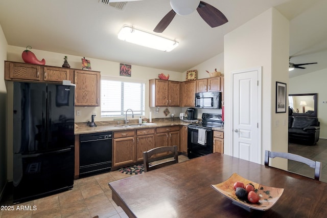 kitchen featuring lofted ceiling, sink, ceiling fan, black appliances, and light tile patterned flooring