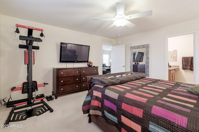 carpeted bedroom featuring connected bathroom and ceiling fan