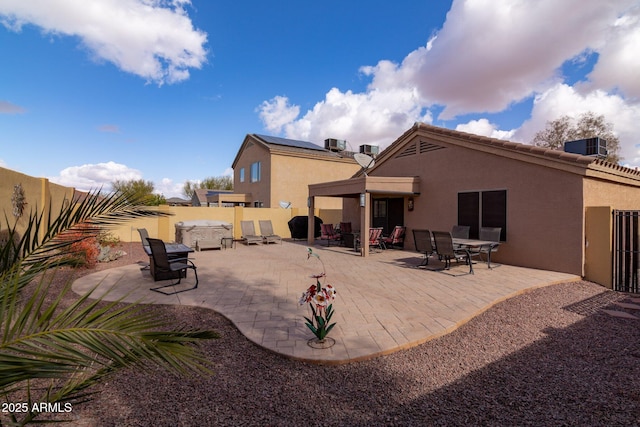 rear view of property featuring cooling unit and a patio