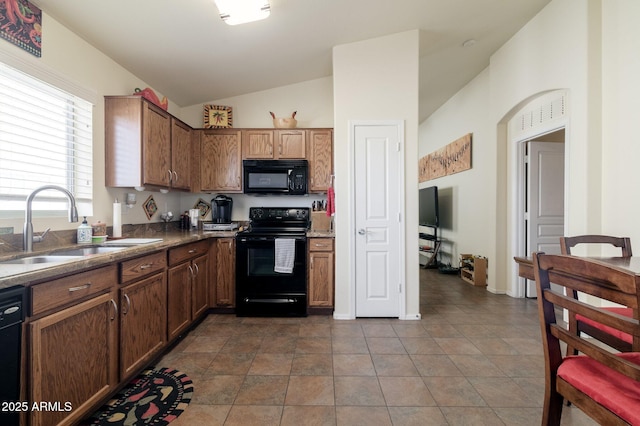 kitchen with lofted ceiling, sink, tile patterned floors, and black appliances