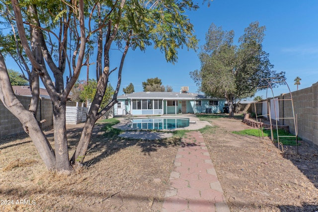 back of house with a patio area and a fenced in pool