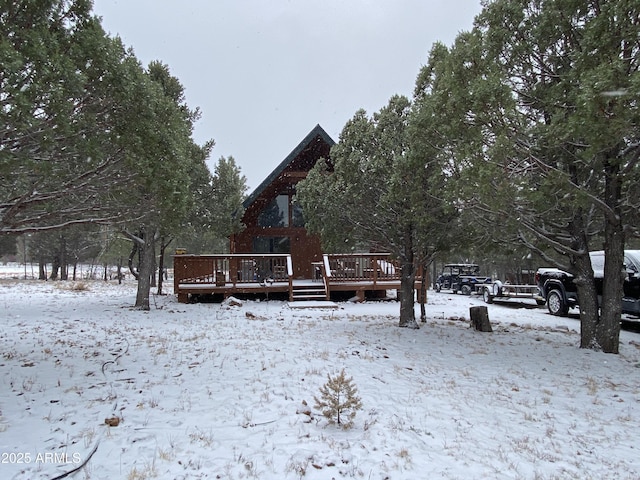 view of snow covered exterior with a wooden deck