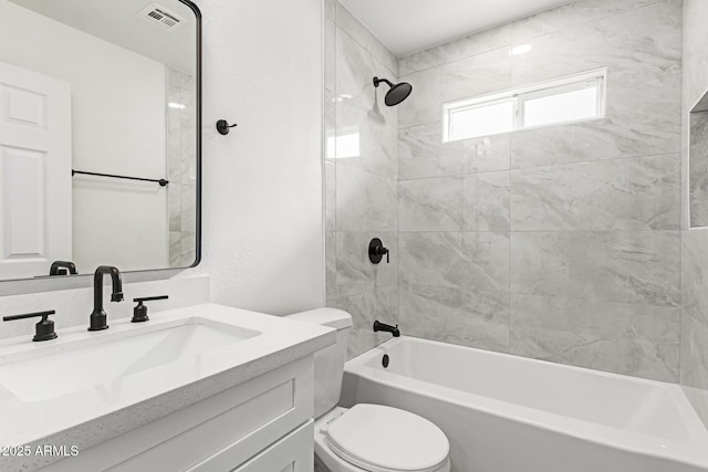 full bathroom with toilet, tiled shower / bath combo, and vanity