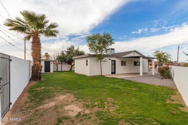 view of yard with a storage shed and a patio area