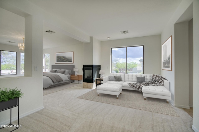 living room with visible vents, a healthy amount of sunlight, and a chandelier