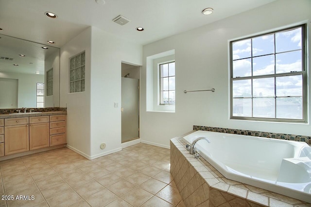 bathroom with tile patterned flooring, visible vents, a shower stall, a bath, and vanity