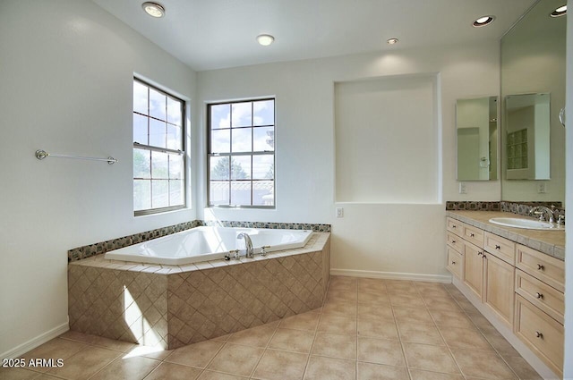 bathroom with baseboards, a bath, vanity, and tile patterned flooring