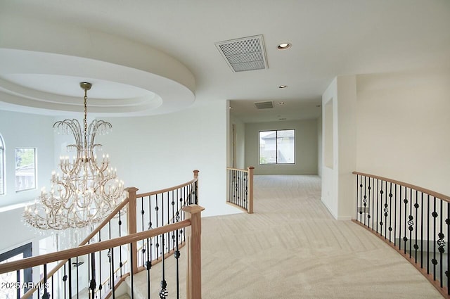 corridor featuring visible vents, an upstairs landing, carpet flooring, recessed lighting, and an inviting chandelier