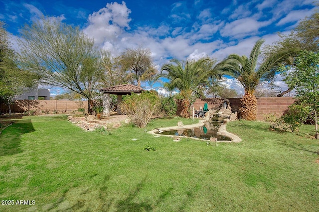 view of yard featuring a gazebo and a fenced backyard