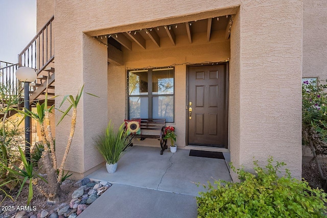 doorway to property with stucco siding