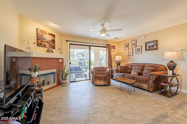 living room featuring visible vents, ceiling fan, and baseboards