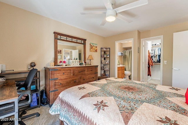 bedroom featuring a walk in closet, a ceiling fan, and ensuite bathroom