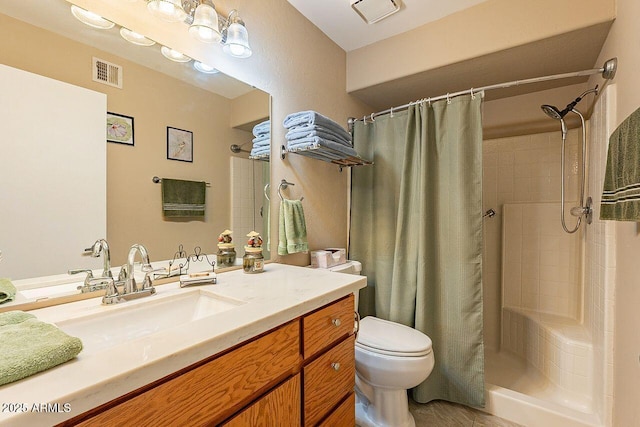 bathroom with visible vents, a tile shower, and toilet