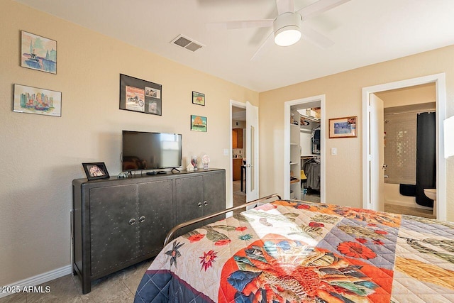 bedroom featuring visible vents, a spacious closet, ensuite bathroom, ceiling fan, and baseboards