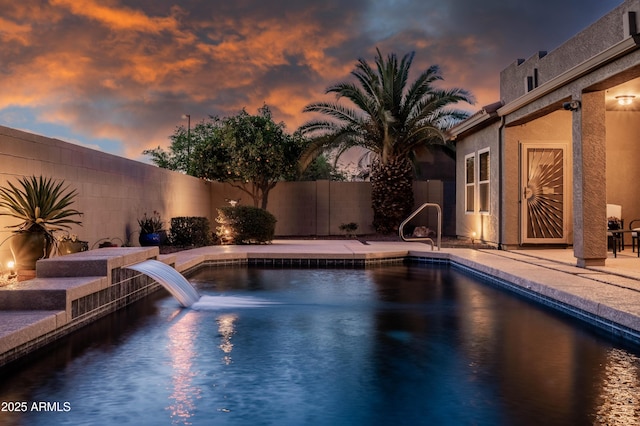 pool at dusk with a fenced in pool, a fenced backyard, and a patio area
