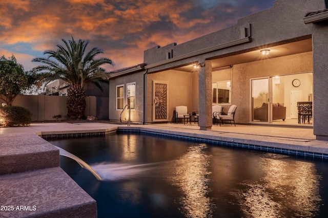 view of pool featuring a fenced in pool, fence, and a patio area