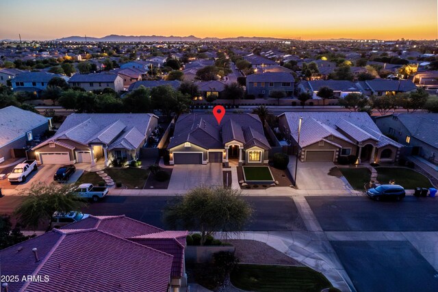 aerial view at dusk featuring a residential view