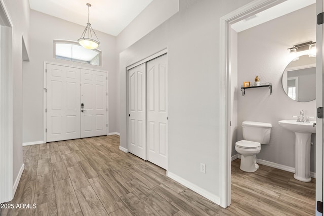 entryway with baseboards and wood finished floors