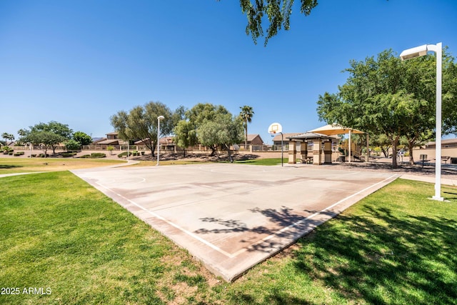 view of sport court featuring a lawn and community basketball court
