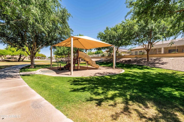 communal playground with a lawn and fence