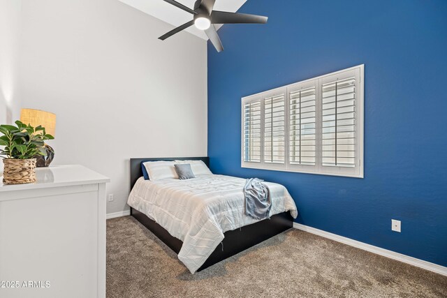 carpeted bedroom featuring baseboards, ceiling fan, and high vaulted ceiling