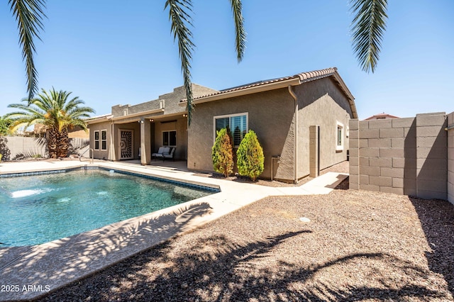 view of swimming pool with a fenced backyard, a fenced in pool, and a patio area