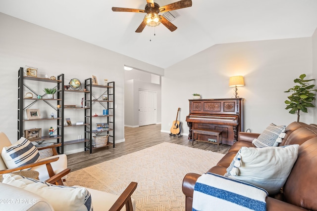 living area featuring visible vents, wood finished floors, lofted ceiling, baseboards, and ceiling fan