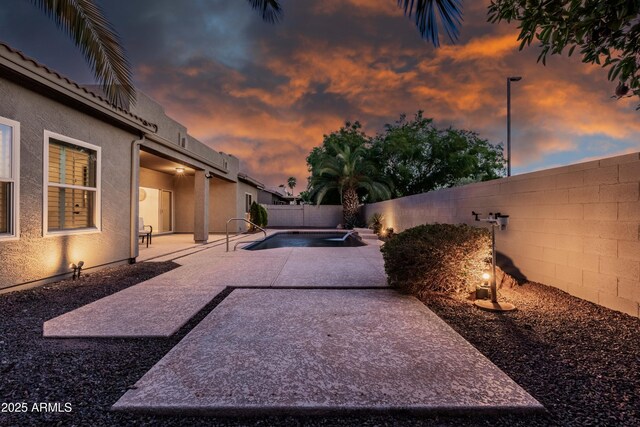view of yard featuring a fenced backyard, a patio, and a jacuzzi