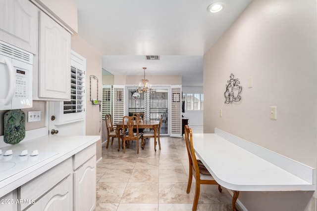 dining area featuring a chandelier