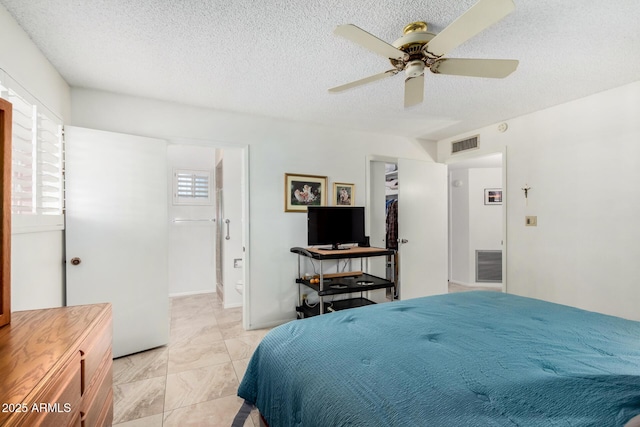 bedroom featuring ceiling fan and a textured ceiling