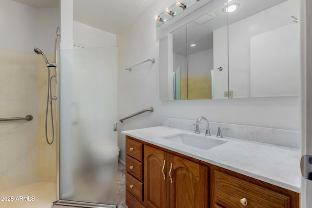 bathroom featuring walk in shower and vanity