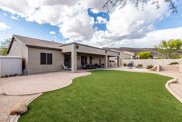 25845 N 44th Ave, Phoenix, AZ 85083 - rear view of property featuring fence, stucco siding, a lawn, a patio, and a tiled roof