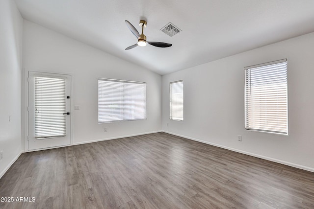 unfurnished room featuring visible vents, baseboards, ceiling fan, dark wood finished floors, and vaulted ceiling