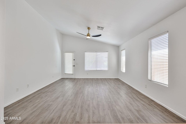 unfurnished living room featuring visible vents, baseboards, vaulted ceiling, wood finished floors, and a ceiling fan