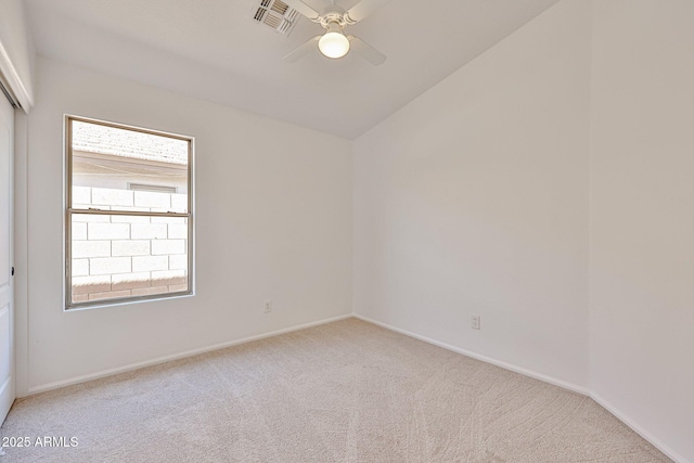 spare room featuring plenty of natural light, carpet flooring, visible vents, and a ceiling fan