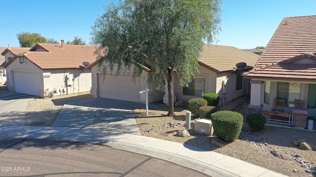 view of front of house featuring stucco siding, an attached garage, and a tile roof